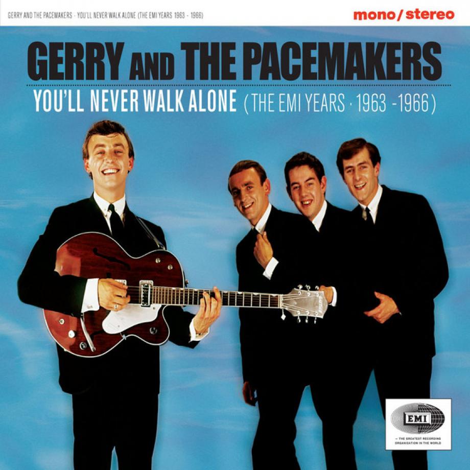 eZu sehen ist das Cover von Gerry an the Pacemakers' You'll never walk alone. Die vierköpfige Band steht in schwarzen Anzügen vor blauem Grund. Gerry steht vorne dran und hält eine rote Gitarre in der Hand.